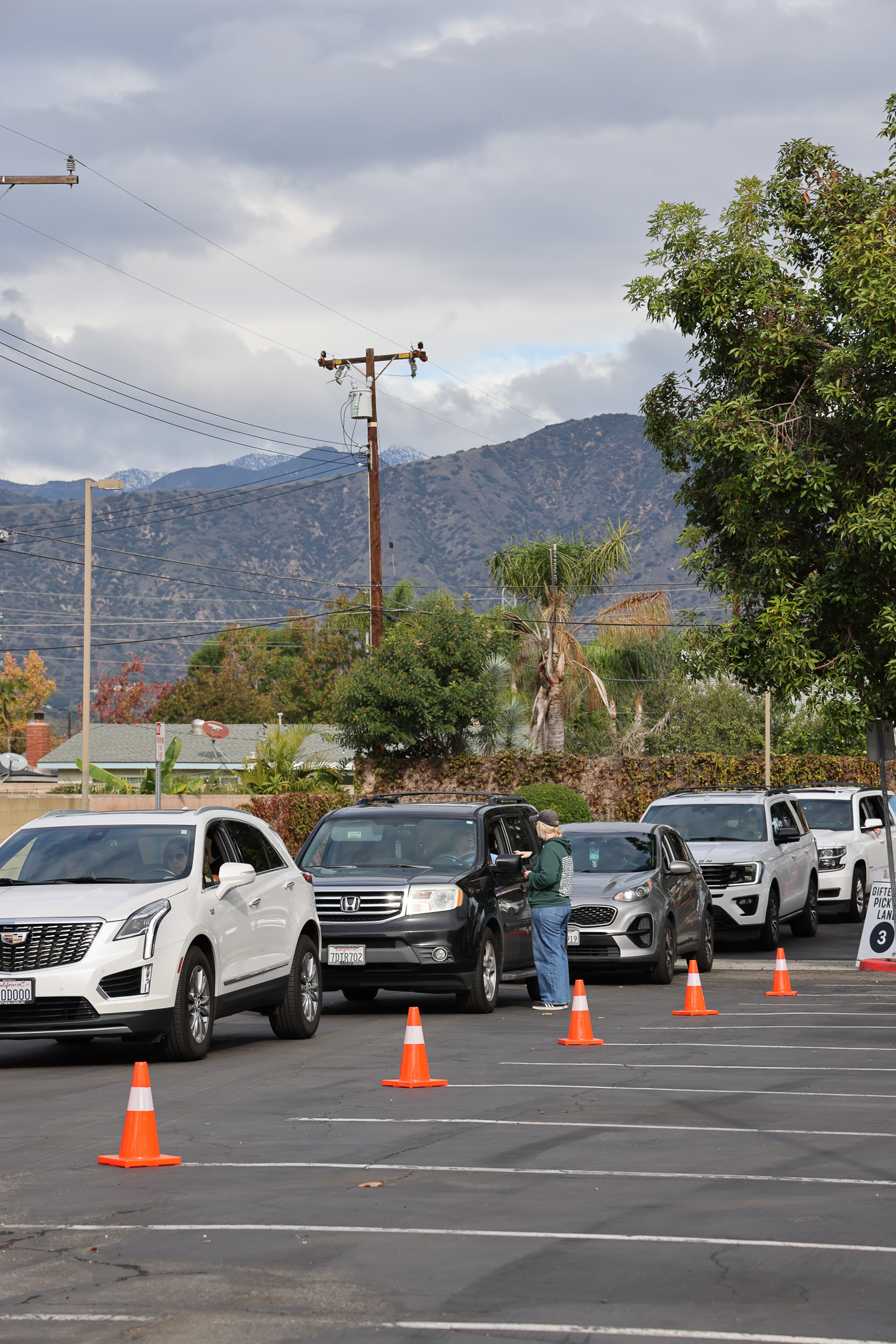 Cars lined up as families receive Giftember boxes at Grace Church